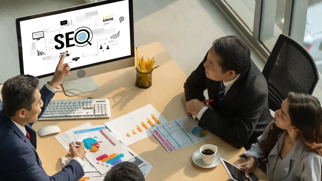 Business team reviewing SEO strategy and performance charts during a meeting.