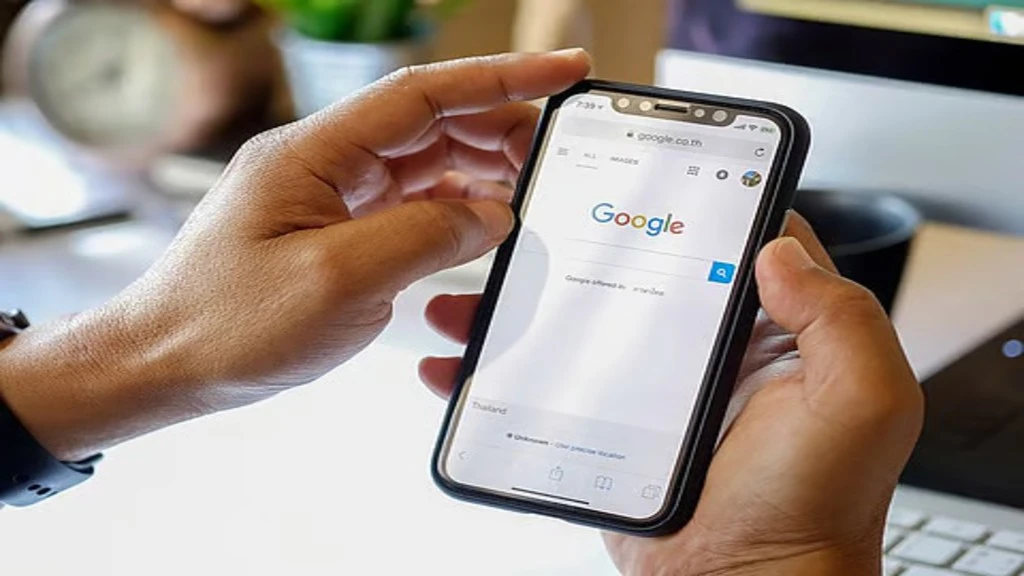 Person using a smartphone to search on Google, representing mobile search dominance.